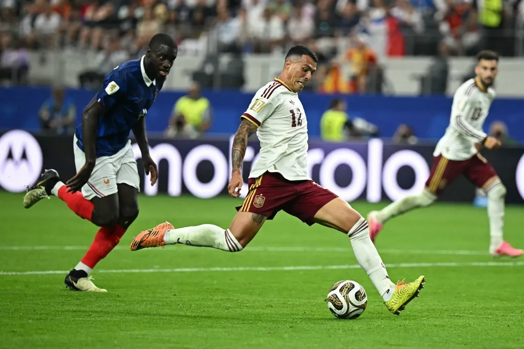 Spain's defender #12 Pedro Porro shoots to score his team's second goal past France's defender #04 Dayot Upamecano during the 2026 World Cup football tournament semi-final match between France and Spain at the Dallas Stadium in Arlington on July 14, 2026.  (Photo by Paul ELLIS / AFP)