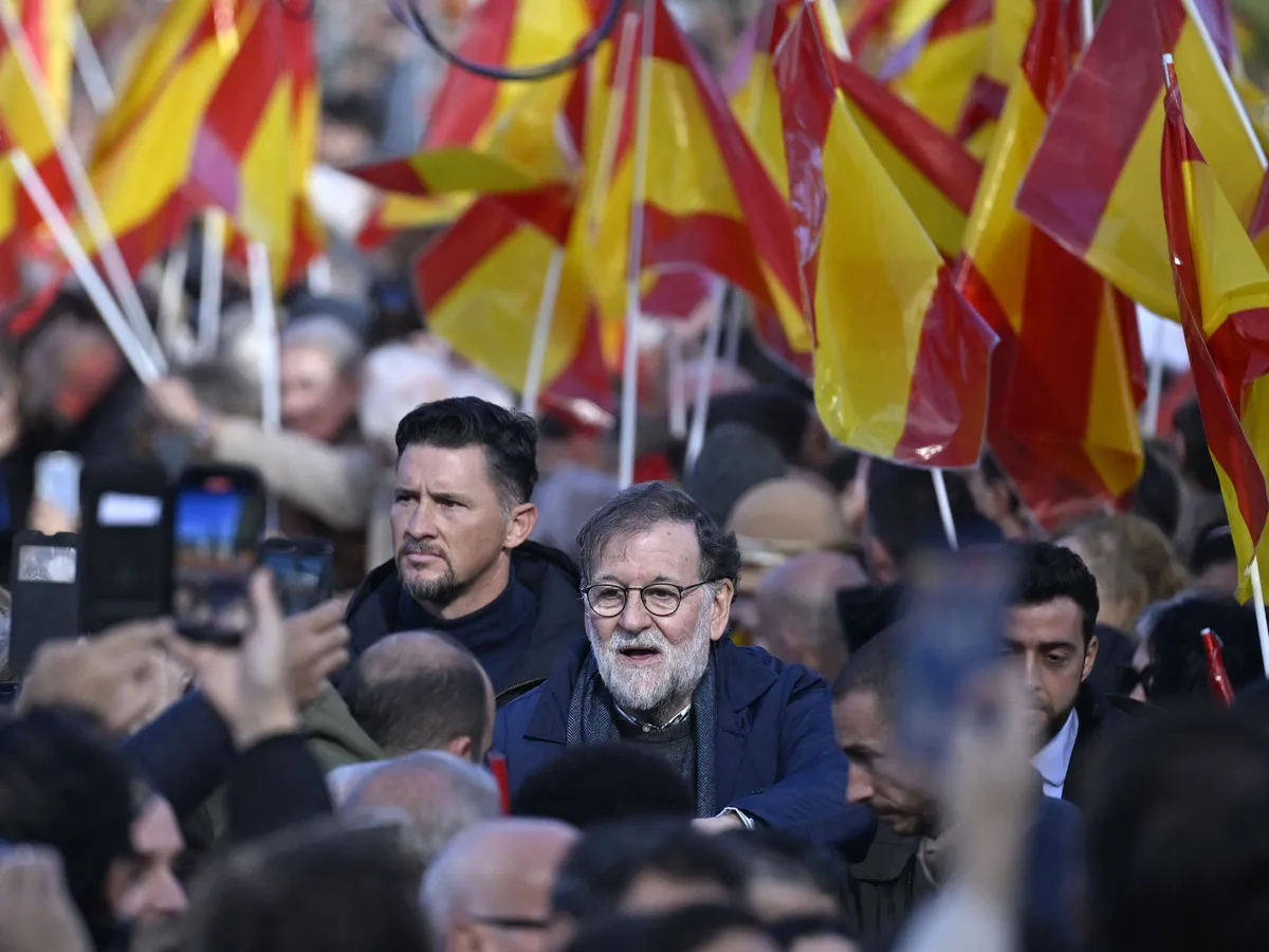 MADRID, SPAIN - NOVEMBER 30: Former Spanish Prime Minister Mariano Rajoy (C) joins a protest organized by the right-wing PP in front of the Temple of Debod to protest Spanish Prime Minister Pedro Sanchez and his government in Madrid, the capital of Spain, on November 30, 2025. Burak Akbulut / Anadolu (Photo by BURAK AKBULUT / Anadolu via AFP)