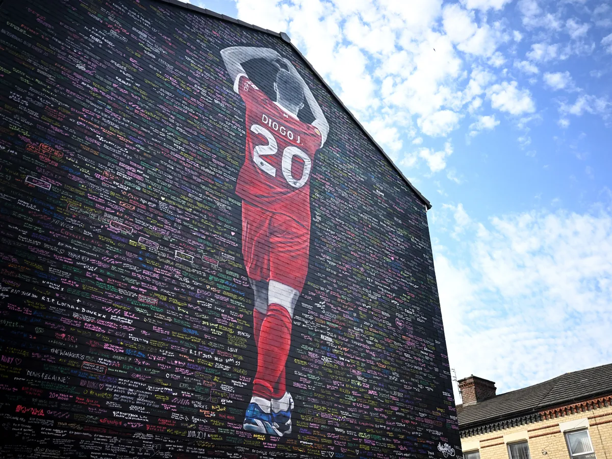 Messages from supporters and well wishers are seen written on a wall in tribute to former Liverpool player Diego Jota, on August 11, 2025. The mural, dedicated to the Portugese footballer who died in a car crash last month, has been created by artist Murwalls and is located adjacent to Anfield stadium in Liverpool, north west England. (Photo by Paul ELLIS / AFP) / RESTRICTED TO EDITORIAL USE - MANDATORY MENTION OF THE ARTIST UPON PUBLICATION - TO ILLUSTRATE THE EVENT AS SPECIFIED IN THE CAPTION