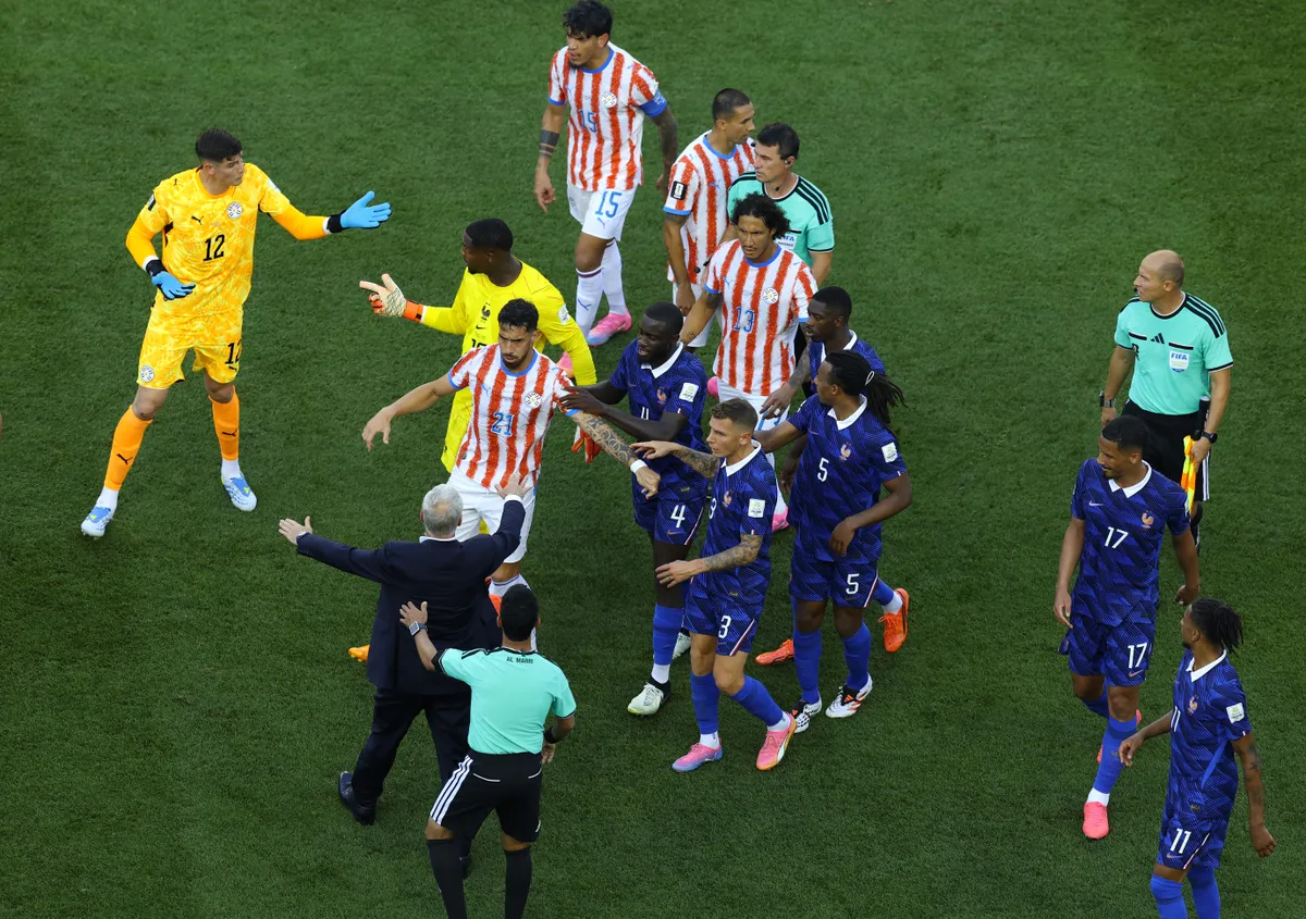 PHILADELPHIA, PENNSYLVANIA - JULY 04: Didier Deschamps, Head Coach of France, separates players before a hydration break in the FIFA World Cup 2026 Round of 16 match between Paraguay and France at Philadelphia Stadium on July 04, 2026 in Philadelphia, Pennsylvania. (Photo by Al Bello/Getty Images)