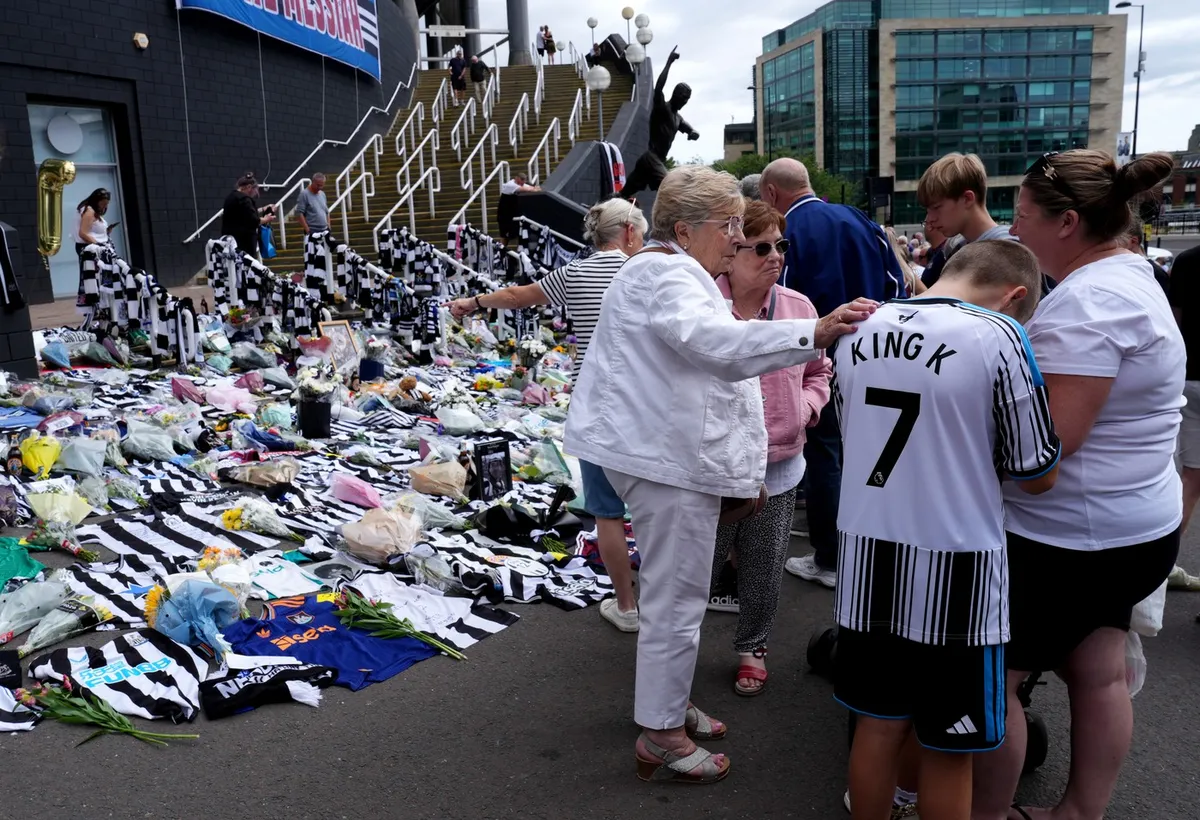 People observe tributes outside St James' Park, Newcastle to former England forward and manager Kevin Keegan who has died aged 75. Picture date: Wednesday July 22, 2026.,Image: 1117884178, License: Rights-managed, Restrictions: Use subject to restrictions. Editorial use only, no commercial use without prior consent from rights holder., Model Release: no  