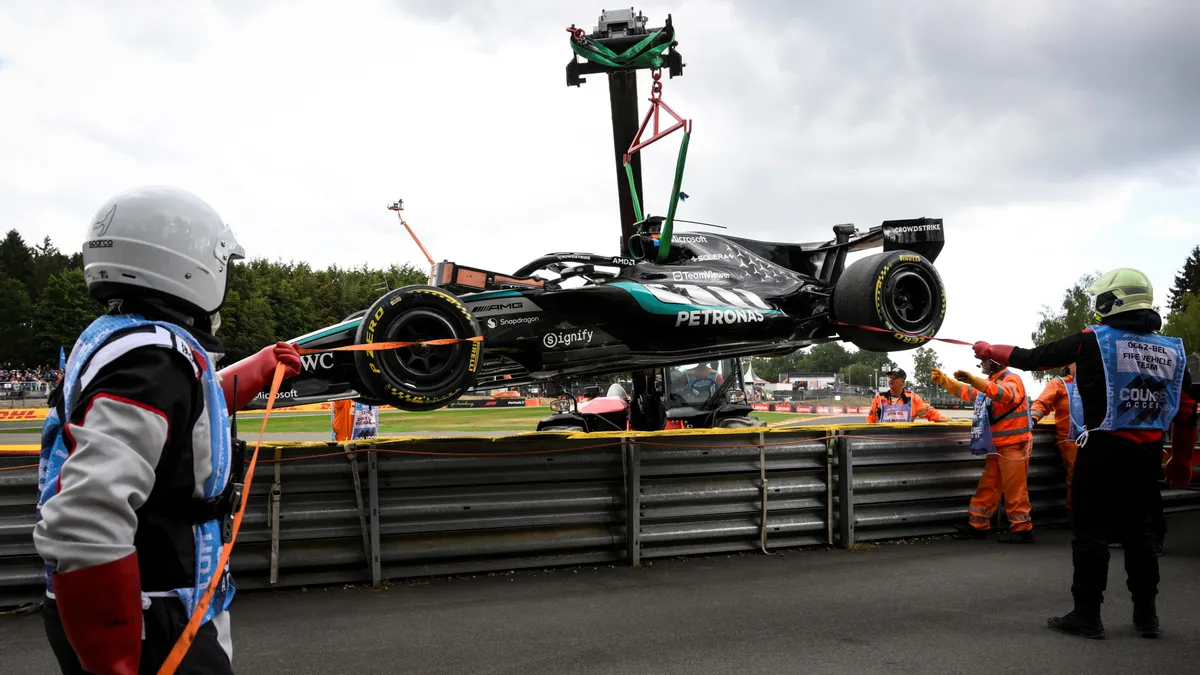 The car of Mercedes' British driver George Russell is taken off the racing track following a collision with Ferrari's British driver Lewis Hamilton during the first round in the Formula One Belgian Grand Prix at the Spa-Francorchamps circuit, in Spa, on July 19, 2026. (Photo by JOHN THYS / AFP)