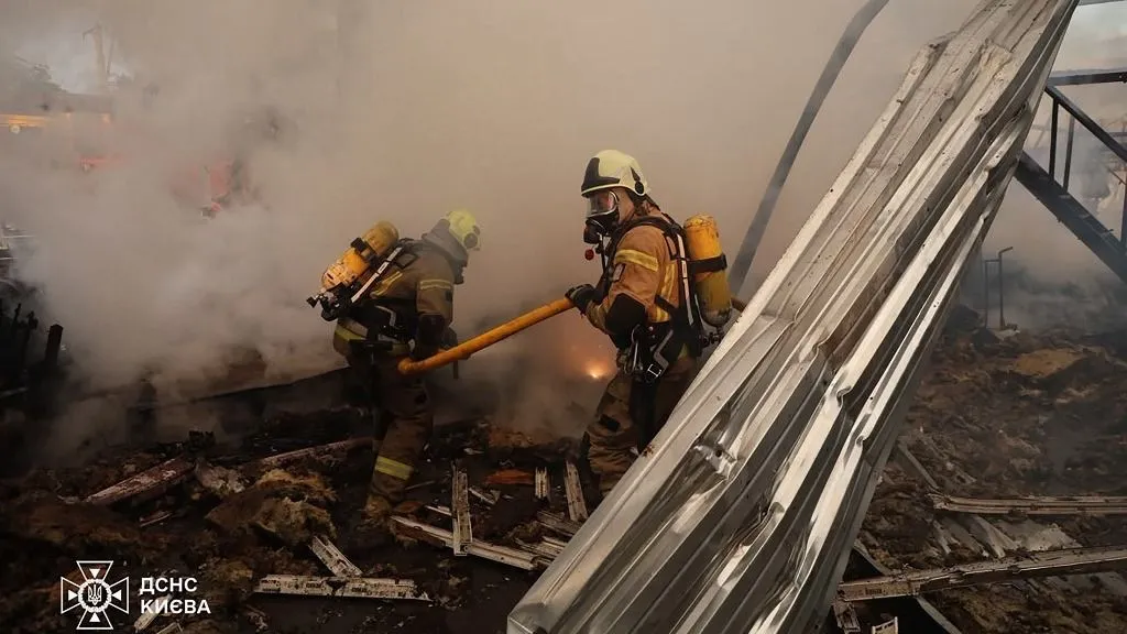 This handout photograph taken and released by Ukrainian State Emergency Service on July 11, 2026 shows firefighters extinguishing a fire in warehouse damaged following Russian missile strikes on the Ukrainian capital of Kyiv early on July 11, 2026, amid the Russian invasion in Ukraine. Ukraine said Russian missile strikes on Kyiv wounded six people, as Moscow escalates attacks on the Ukrainian capital. AFP journalists in Kyiv heard two series of explosions in the early hours of Saturday, with an air alert siren sounding minutes after the first blast. (Photo by Handout / Ukrainian State Emergency Service / AFP)