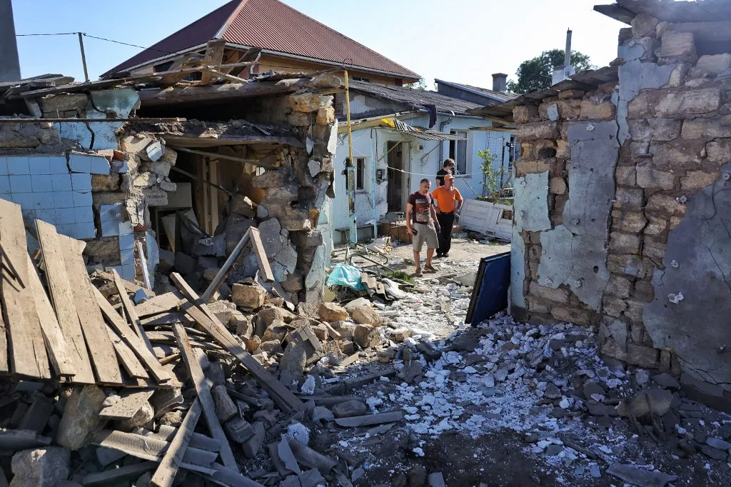 Men stand outside a residential building damaged in a drone strike in Odesa, Ukraine, on July 6, 2026. The city was targeted with drones, resulting in damage to residential buildings in the Kyivskyi district and a garage cooperative in the Khadzhybeiskyi district. At least one person is reported injured. (Photo by Nina Liashonok/Ukrinform/NurPhoto) (Photo by Nina Liashonok / NurPhoto via AFP), rakétatámadás