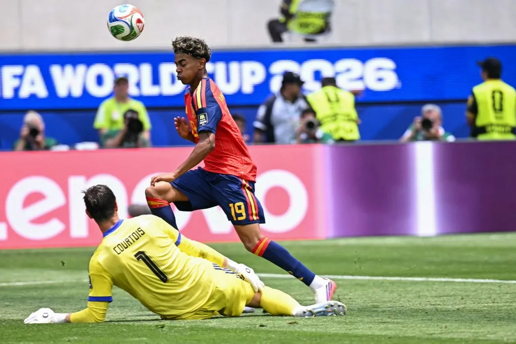 Spain's forward #19 Lamine Yamal and Belgium's goalkeeper #01 Thibaut Courtois fight for the ball during the 2026 World Cup football tournament quarter-final match between Spain and Belgium at the Los Angeles Stadium in Inglewood on July 10, 2026.  (Photo by Paul ELLIS / AFP)
