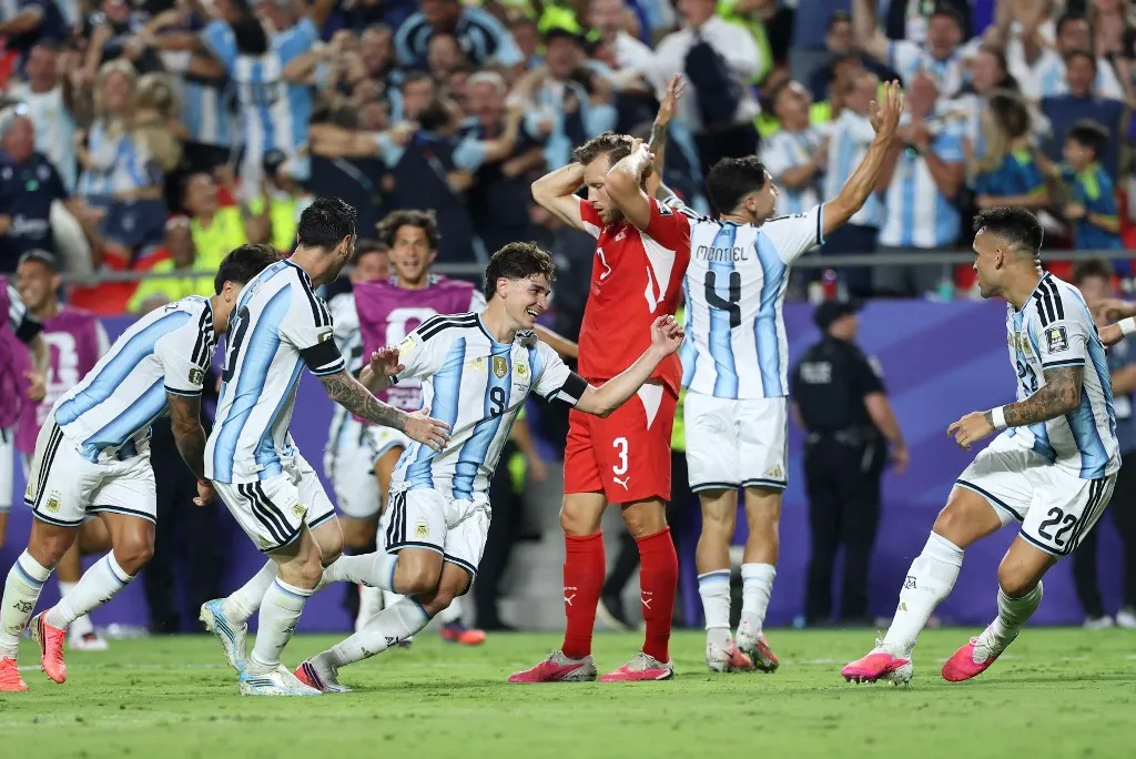Argentina's forward #09 Julian Alvarez celebrates scoring his team's second goal as Switzerland's defender #03 Silvan Widmer reacts during the 2026 World Cup football tournament quarter-final match between Argentina and Switzerland at the Kansas City Stadium in Kansas City on July 11, 2026. (Photo by Thomas COEX / AFP)