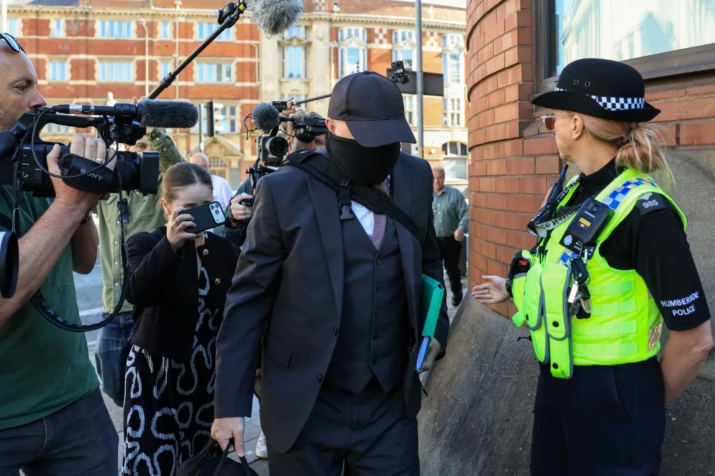 Robert Bush (C), a funeral director guilty of defrauding and deceiving grieving families, arrives ahead of his sentencing outside the Hull Crown Court in the Lowgate area of Kingston upon Hull on July 27, 2026. (Photo by Darren Staples / AFP)