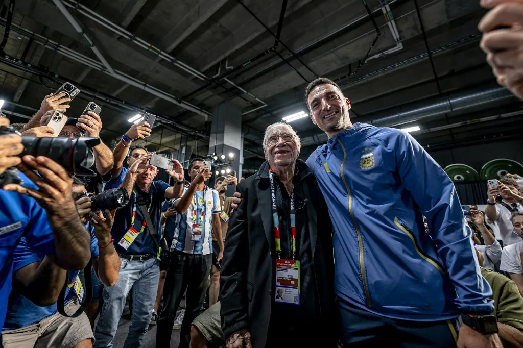 Argentine sports journalist Enrique Macaya Marquez attends his eighteenth World Cup at the age of 91, alongside Argentina national coach Lionel Scaloni, during a press conference for Argentina MD-1 at AT&T Stadium on June 26, 2026, in Dallas, United States. (Photo by Stefan Koops/EYE4IMAGES/NurPhoto) (Photo by Stefan Koops / NurPhoto via AFP)