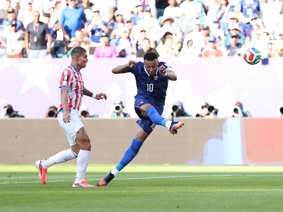 PHILADELPHIA, PENNSYLVANIA - JULY 04: Kylian Mbappe #10 of France shoots against Juan Jose Caceres #4 of Paraguay during the FIFA World Cup 2026 Round of 16 match between Paraguay and France at Philadelphia Stadium on July 04, 2026 in Philadelphia, Pennsylvania. (Photo by Dan Mullan/Getty Images)