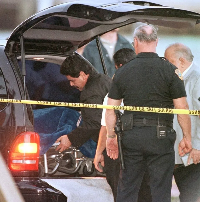 Versace, A member of the Miami Medical Examiner's office places a stretcher, carrying the body of serial killer Andrew Cunanan, into a van 24 July after the body was removed from a boathouse in Miami Beach. According to authorities, Cunanan shot himself after he was trapped inside the boathouse 23 July by a SWAT team and the Miami police.  AFP PHOTO/Roberto SCHMIDT (Photo by ROBERTO SCHMIDT / AFP)