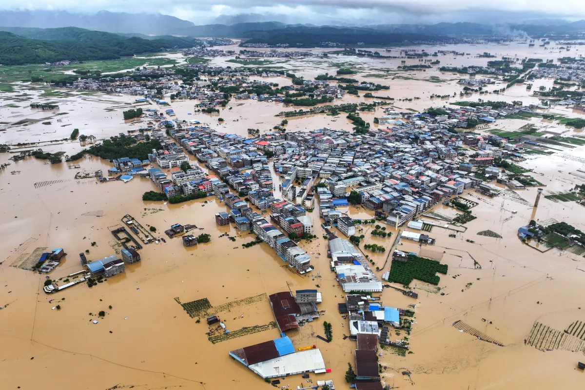 (260706) -- NANNING, July 6, 2026 (Xinhua) -- A drone photo taken on July 6, 2026 shows the flooded downstream areas of the Liulan Reservoir after it was breached due to heavy rains in Hengzhou, Nanning City, south China's Guangxi Zhuang Autonomous Region. A severe breach occurred at a reservoir in Hengzhou, Nanning City, in south China's Guangxi Zhuang Autonomous Region on Monday morning, prompting an immediate escalation of the emergency response, local authorities said. 
   Given the severe flood control situation, the city raised its emergency response for flood control from Level III to Level I, effective at 11:30 a.m. on Monday.
   The Liulan Reservoir, a medium-sized water conservancy facility in the region, reported the dam breach on Monday morning. In response, local departments of emergency management, fire rescue and water resources have been mobilized for rescue and relief operations, and the evacuation of affected residents is underway. (Xinhua/Cao Yiming) (Photo by Cao Yiming / Xinhua via AFP)