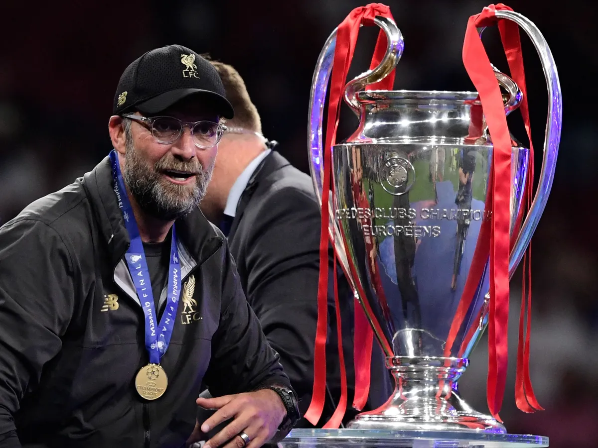 Liverpool's German manager Jurgen Klopp looks at the trophy after winning the UEFA Champions League final football match between Liverpool and Tottenham Hotspur at the Wanda Metropolitano Stadium in Madrid on June 1, 2019. (Photo by JAVIER SORIANO / AFP)