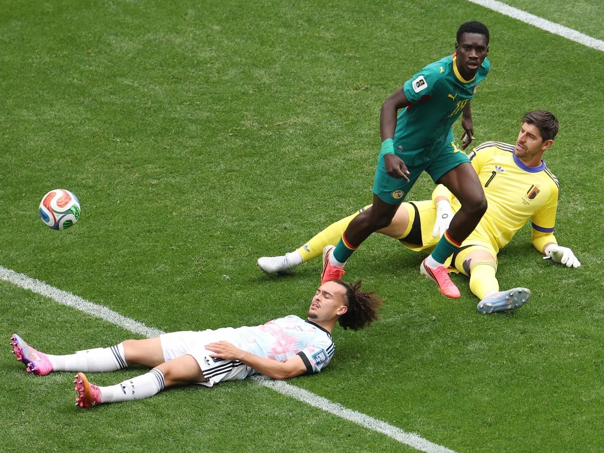 SEATTLE, WASHINGTON - JULY 01: Ismaila Sarr #18 of Senegal celebrates scoring his team's second goal while Thibaut Courtois #1 and Arthur Theate #3 of Belgium show dejection during the FIFA World Cup 2026 Round Of 32 match between Belgium and Senegal at Seattle Stadium on July 01, 2026 in Seattle, Washington.   Emilee Chinn/Getty Images/AFP (Photo by Emilee Chinn / GETTY IMAGES NORTH AMERICA / Getty Images via AFP)