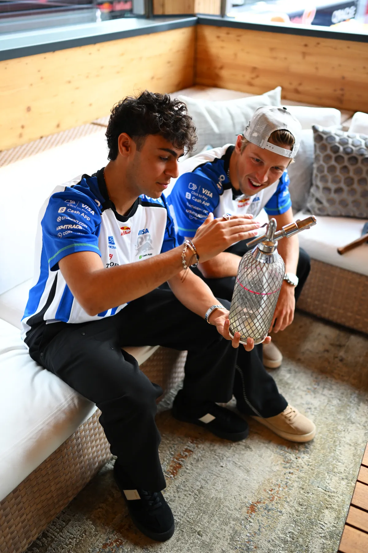 BUDAPEST, HUNGARY - JULY 23: Arvid Lindblad of Great Britain and Visa Cash App Racing Bulls and Liam Lawson of New Zealand and Visa Cash App Racing Bulls talk during previews ahead of the F1 Grand Prix of Hungary at Hungaroring on July 23, 2026 in Budapest, Hungary. (Photo by Rudy Carezzevoli/Getty Images)