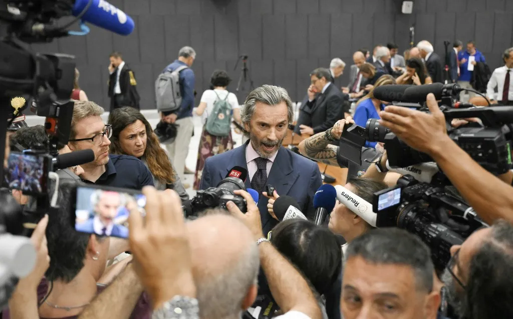 Giovanni Paolo Accini, Lawyer of former CEO of Atlantia Giovanni Castellucci, speaks with media in the Courthouse after the verdict in the case of the Morandi Bridge collapse nearly eight years ago that killed 43 people in one of the country's worst infrastructure disasters, in Genoa on July 16, 2026. A Genoa court sentenced a former executive of Italian motorway network Autostrade per l'Italia (ASPI) to 12 years in jail on Thursday for his role in a deadly bridge collapse that killed 43 people in 2018. (Photo by Marco BERTORELLO / AFP)