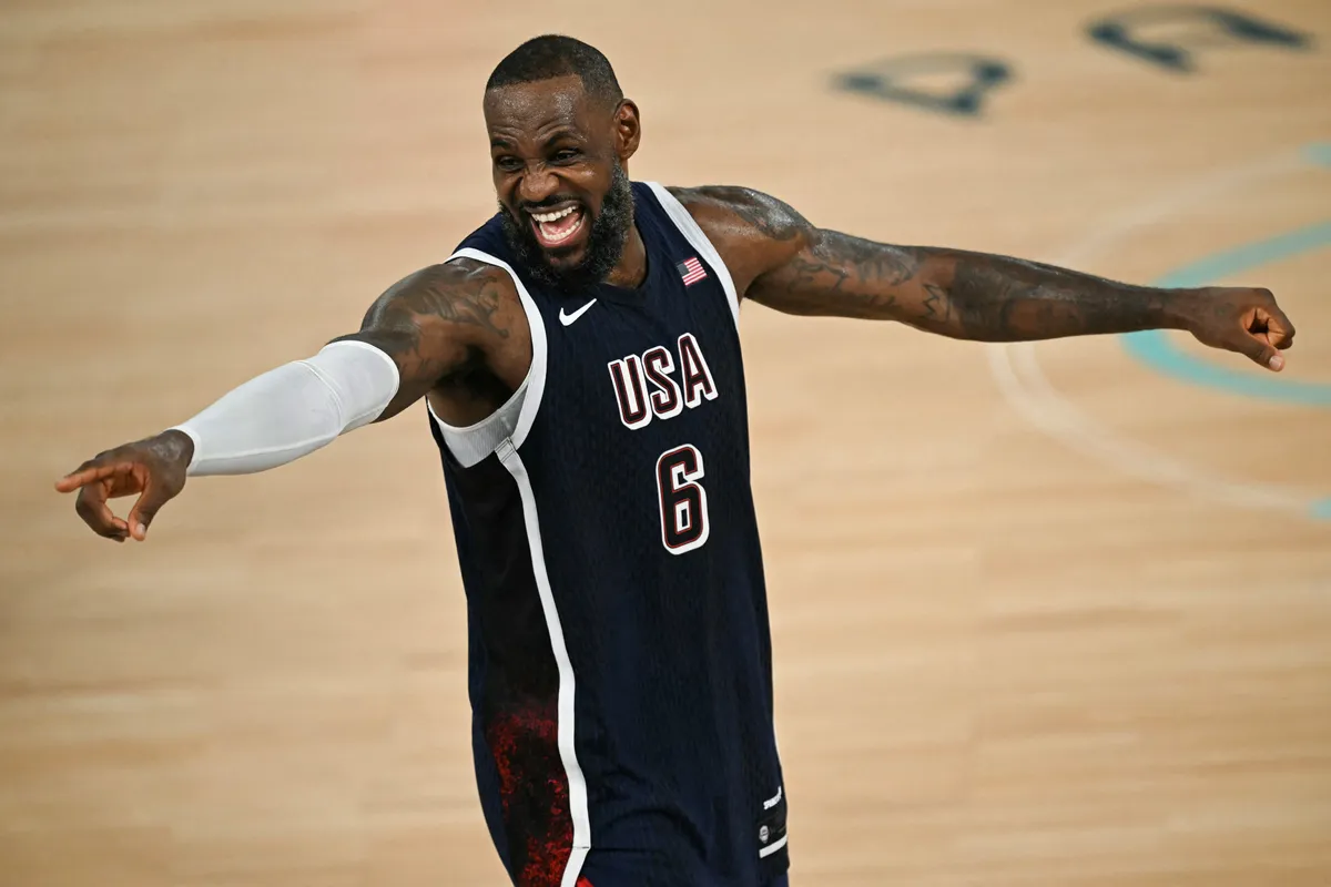(FILES) USA's #06 LeBron James celebrates his team's victory after winning the men's Gold Medal basketball match between France and USA during the Paris 2024 Olympic Games at the Bercy  Arena in Paris on August 10, 2024. LeBron James announced on July 24, 2026 he will play for the Philadelphia 76ers next season, with the 41-year-old NBA superstar hoping to transform another franchise into a championship team. (Photo by Paul ELLIS / AFP)