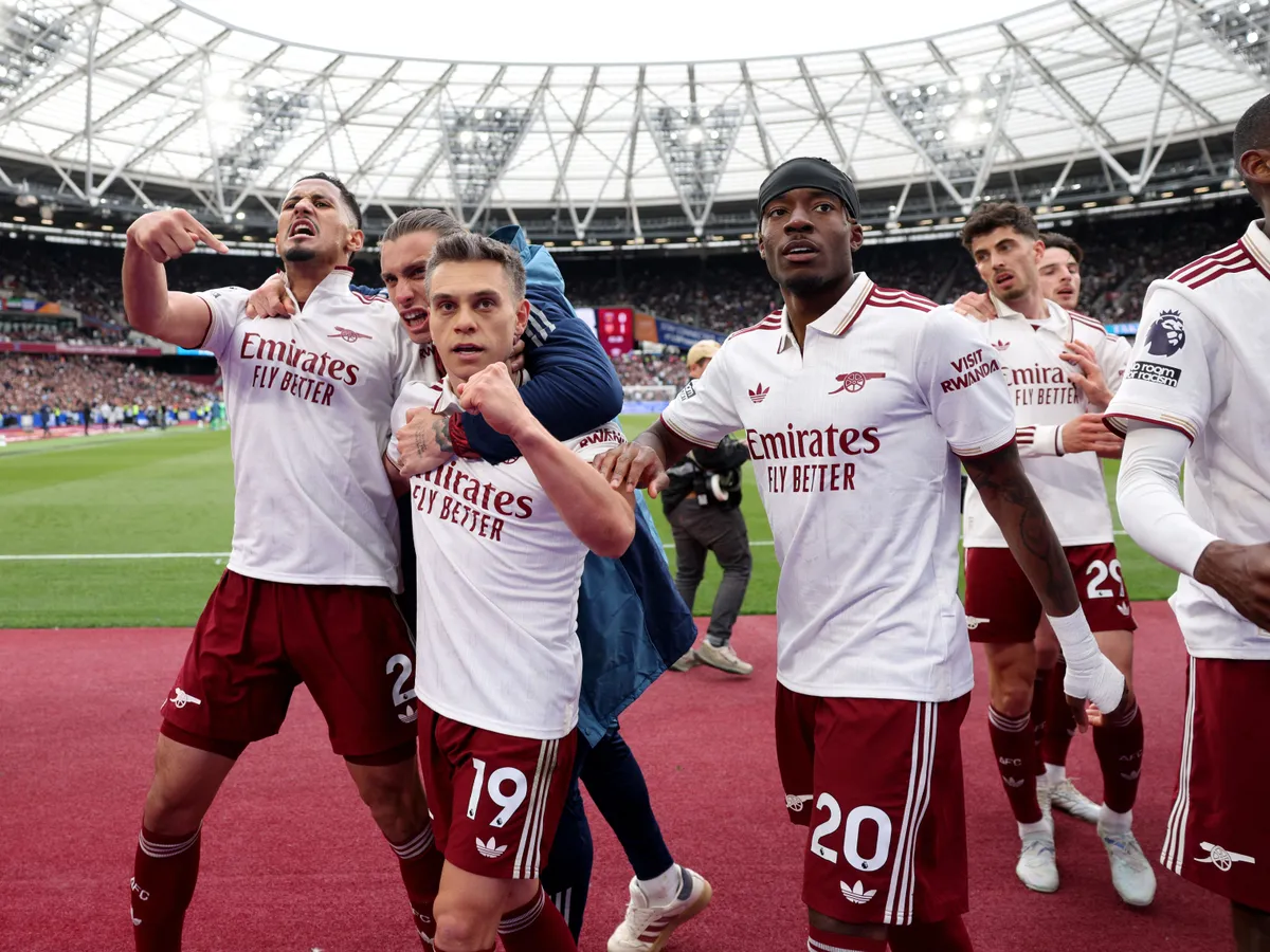 Arsenal's Belgian midfielder #19 Leandro Trossard celebrates scoring the team's first goal during the English Premier League football match between West Ham United and Arsenal at the London Stadium, in east London on May 10, 2026. (Photo by Adrian DENNIS / AFP) / RESTRICTED TO EDITORIAL USE. No use with unauthorized audio, video, data, fixture lists, club/league logos or 'live' services. Online in-match use limited to 120 images. An additional 40 images may be used in extra time. No video emulation. Social media in-match use limited to 120 images. An additional 40 images may be used in extra time. No use in betting publications, games or single club/league/player publications. / 