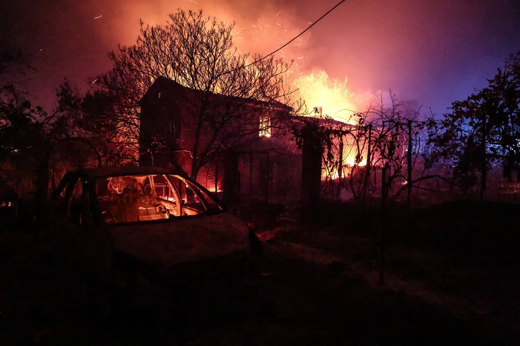 A house is engufled in flames in Cotignac, southeastern France, on July 22, 2026. A wildfire advancing at surprising speed in southern France forced the evacuation of nearly 400 people from several villages on July 21, 2026, the top official for the Var r