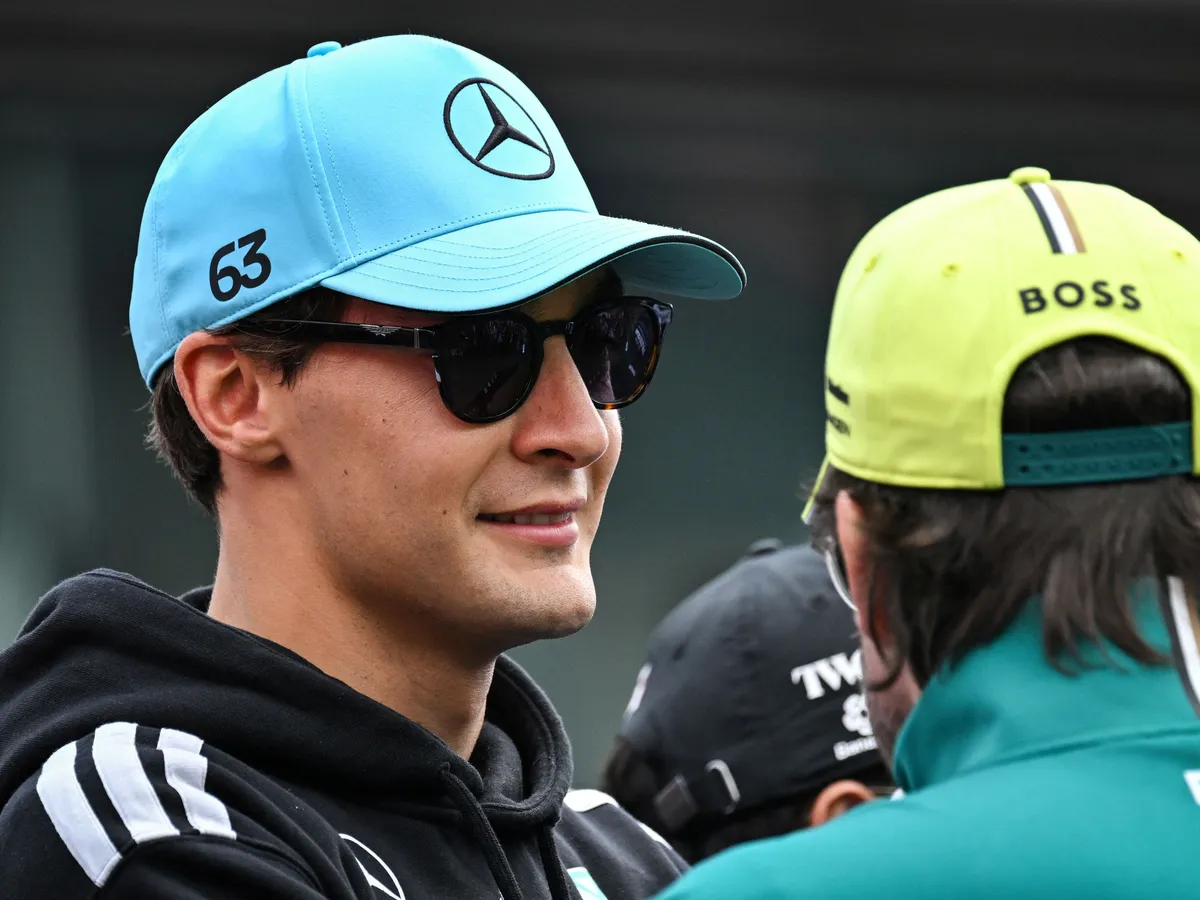 Mercedes' British driver George Russell (L) and Aston Martin's Spanish driver Fernando Alonso speak together as they take part in the drivers parade ahead of the Formula One Belgian Grand Prix at the Spa-Francorchamps circuit, in Spa, on July 19, 2026. (Photo by Andrej ISAKOVIC / AFP)