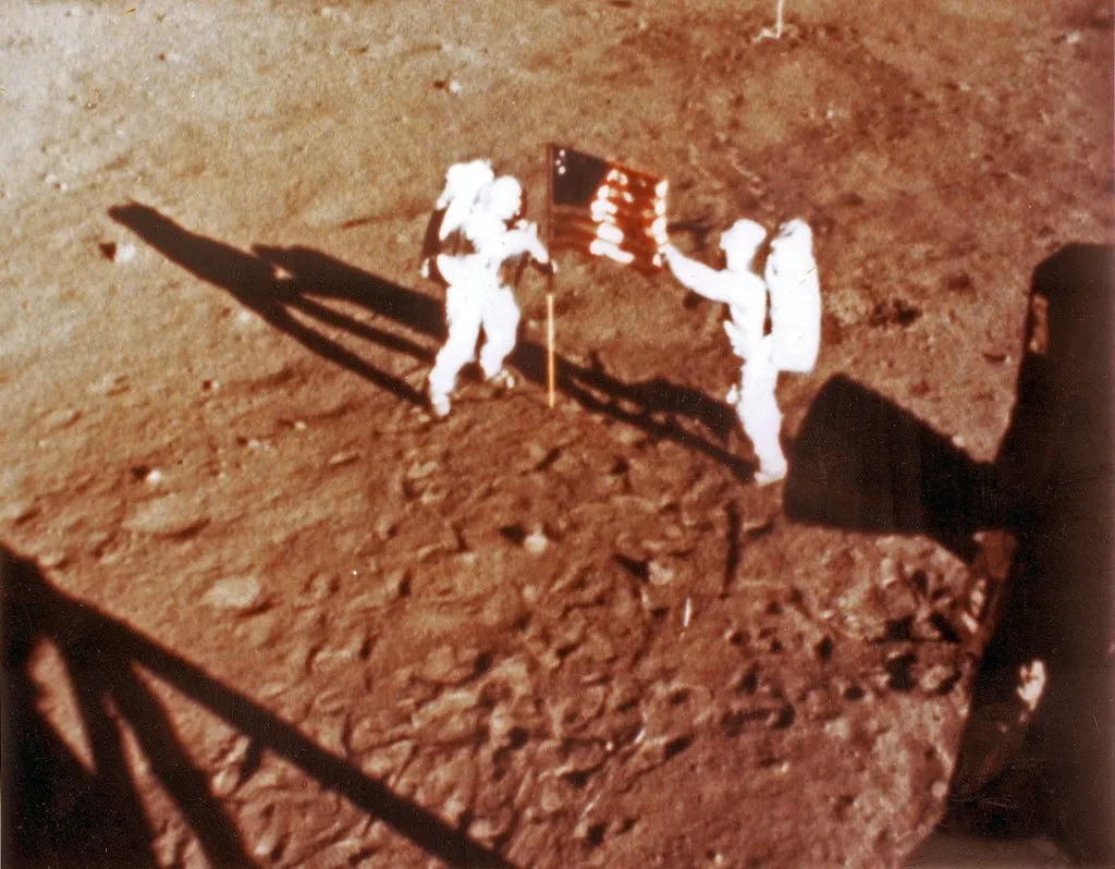 TO GO WITH AFP STORY "US-SPACE-MOON-ANNIVERSARY-ARMSTRONG" US astronauts Neil Armstrong and "Buzz" Aldrin deploy the US flag on the lunar surface on July 20, 1969 during the Apollo 11 lunar landing mission. Armstrong, who turns 80 on August 5, 2010, became the first human to set foot on the moon on July 20, 1969 before the eyes of hundreds of millions of television viewers worldwide, who gazed in awe. With one small step off a ladder, Armstrong placed mankind's first footprint on an extraterrestrial world and gained instant hero status.        AFP PHOTO/NASA/HO         ++RESTRICTED TO EDITORIAL USE++ (Photo by NASA / AFP)