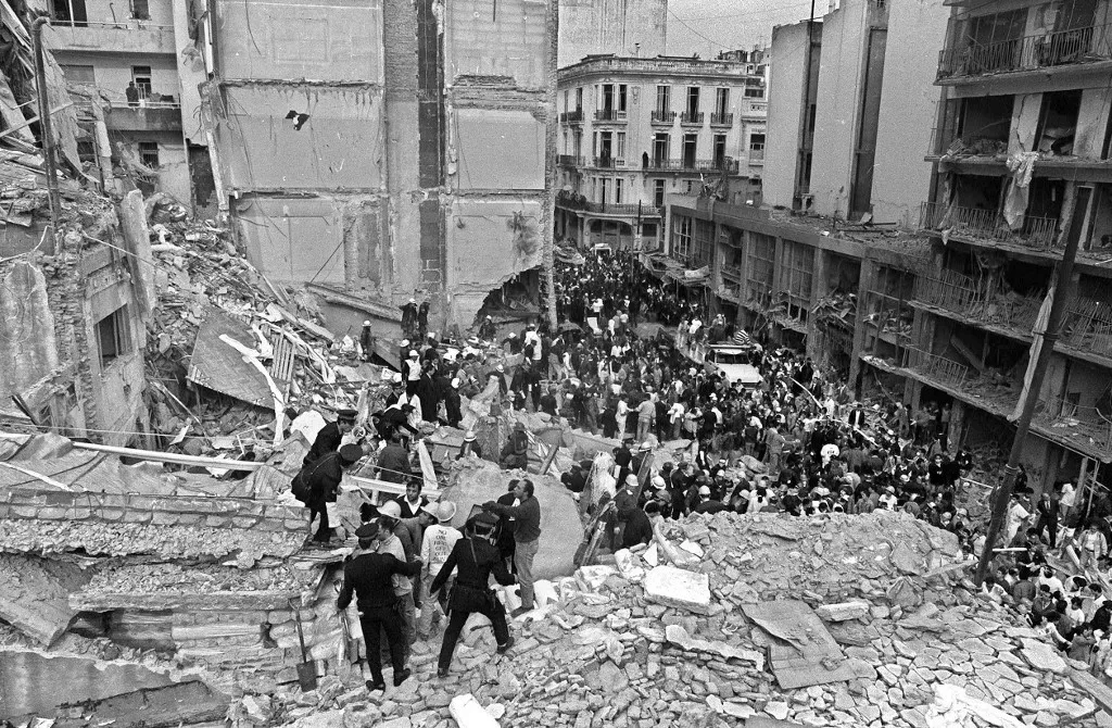 terror, (FILE) Firemen and policemen search for wounded people after a bomb exploded at the Argentinian Israelite Mutual Association (AMIA in Spanish) in Buenos Aires, 18 July 1994. 85 people died in the attack which 10th anniversary will be commemorated next Sunday. The Argentine Justice has been unable to discover who has been behind the bombing up to this moment. AFP PHOTO/Ali BURAFI (Photo by Ali BURAFI / AFP)