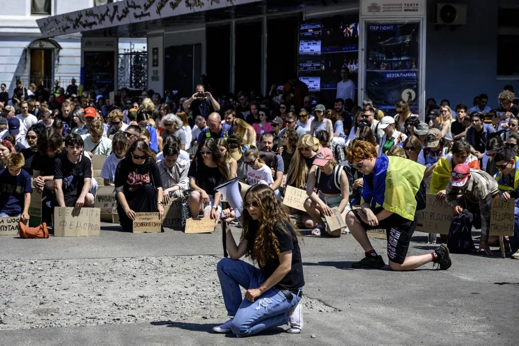 Activists hold handmade cardboard placards during a spontaneous protest after President Volodymyr Zelenskyy decides not to nominate Mykhailo Fedorov for the post of Minister of Defence in the new Ukrainian government, in Kyiv, Ukraine, on July 16, 2026. (Photo by Maxym Marusenko/NurPhoto) (Photo by Maxym Marusenko / NurPhoto via AFP)