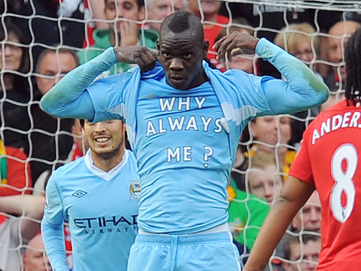 Manchester City's Italian striker Mario Balotelli celebrates scoring the opening goal of the English Premier League football match between Manchester United and Manchester City at Old Trafford in Manchester, north-west England on October 23, 2011. AFP PHOTO/ANDREW YATES

RESTRICTED TO EDITORIAL USE. No use with unauthorized audio, video, data, fixture lists, club/league logos or live services. Online in-match use limited to 45 images, no video emulation. No use in betting, games or single club/league/player publications (Photo by ANDREW YATES / AFP)