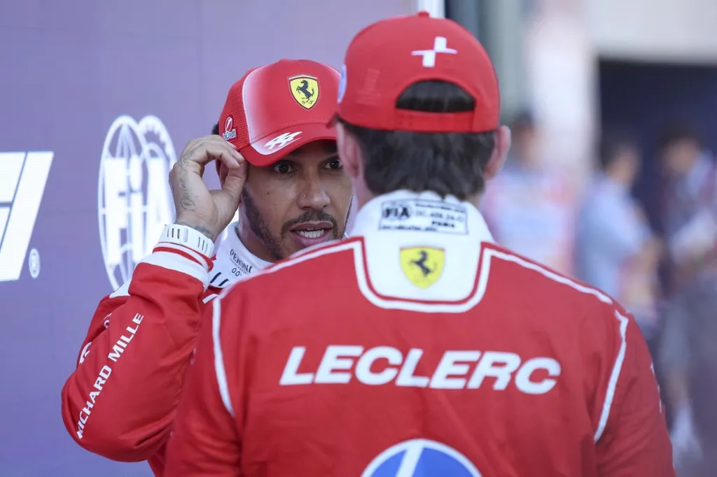 Lewis Hamilton of Great Britain and Scuderia Ferrari talks with Charles Leclerc after the qualifying session ahead of the Formula 1 Lenovo Austrian Grand Prix at Red Bull Ring in Spielberg, Austria, on June 27, 2026. (Photo by Piotr Zajac/NurPhoto) (Photo by Piotr Zajac / NurPhoto via AFP)