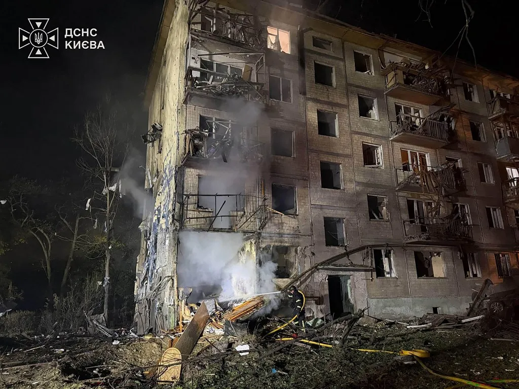 This handout photograph taken and released by Ukrainian State Emergency Service on August 1, 2026 shows rescuers working outside a multi-storey residential building damaged following massive Russian ballistic missile strikes in the Ukrainian capital of Kyiv, amid the Russian invasion in Ukraine. Russian strikes on Ukraine's capital killed at least nine people and wounded more than two dozen others, local officials said, hours after Kyiv's mayor had warned of a ballistic missile attack. (Photo by Handout / Ukrainian State Emergency Service / AFP)