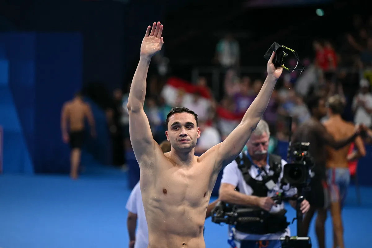 Hungary's Kristof Milak reacts after winning the final of the men's 100m butterfly swimming event during the Paris 2024 Olympic Games at the Paris La Defense Arena in Nanterre, west of Paris, on August 3, 2024. (Photo by Jonathan NACKSTRAND / AFP)