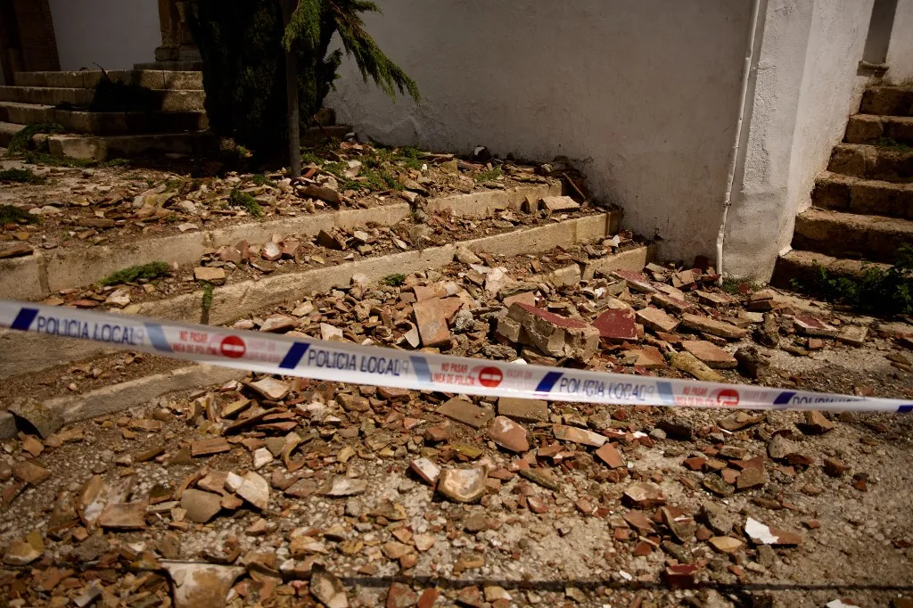 A picture taken on August 15, 2026 shows broken tiles on the floor at the entrance of San Miguel Bajo Church, in El Albayzin barrio of Granada, Andalusia, after an overnight seismic tremor. No casualties or serious and widespread structural damage were reported as a 5-level magnitude earthquake rocks Spain's tourist jewel Granada in the night of August 14-15, 2026. (Photo by Enrique Fajardo / AFP)