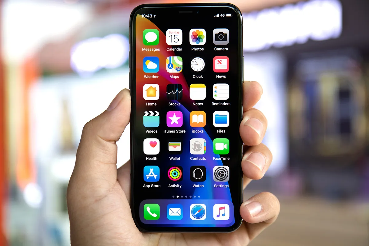 Koh Samui, Thailand - April 15, 2018: Man hand holding iPhone X with home screen IOS. iPhone 10 was created and developed by the Apple inc.