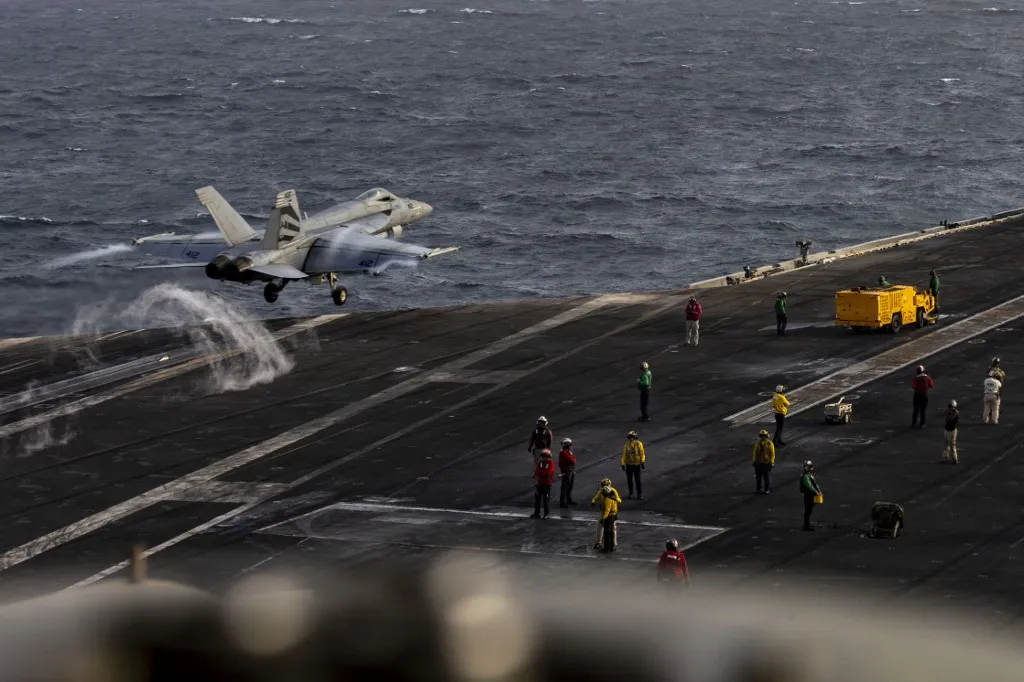 (FILES) This US Navy handout photograph released on August 4, 2026, by US Central Command Public Affairs shows an F/A-18E Super Hornet launching from the flight deck of Nimitz-class aircraft carrier USS Abraham Lincoln on July 31, 2026. Some sailors have reportedly tried throwing themselves into the sea, basic supplies can run short and sanitation is going awry: life on America's giant Abraham Lincoln aircraft carrier is increasingly difficult as the Iran war drags on. The ship -- now in its ninth month of deployment -- is expected to be replaced in the Middle East by another carrier, the George Washington, in a move sure to be welcomed by the Lincoln's crew and their loved ones. (Photo by various sources / AFP) / RESTRICTED TO EDITORIAL USE - MANDATORY CREDIT "AFP PHOTO / US NAVY / NAVCENT PUBLIC AFFAIRS" - HANDOUT - NO MARKETING NO ADVERTISING CAMPAIGNS - DISTRIBUTED AS A SERVICE TO CLIENTS

Attention editors: AFP covers the war in the Middle East through its extensive regional network, including bureaus in Tehran, Jerusalem, and several neighboring countries. Since the start of the conflict, journalists have been working under increasingly restrictive conditions. Authorities in several countries have limited reporters' movements, photo and live video coverage from sensitive locations. Some governments and armed groups have banned images of missile or drone strikes and other security-related sites. / TO GO WITH AFP FOCUS STORY BY W.G. DUNLOP- AUGUST 14, 2026.