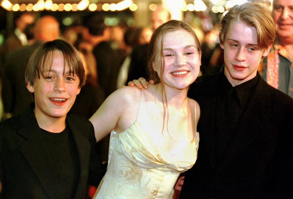 The two Culkin brothers, Kieran(L) and Macaulay(R) pose with New York theater actress Rachel Minor(C) upon their arrival to the premiere of the new Miramax film "The Mighty," in which Kieran has a role, at the Cineplex Odeon Theater in Century City, Calif