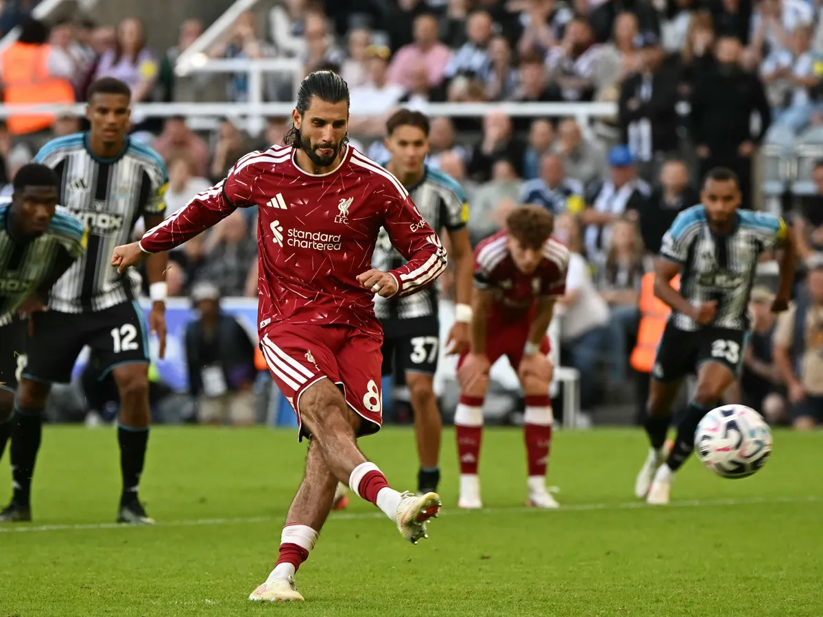 Liverpool's Hungarian midfielder #08 Dominik Szoboszlai scores their second goal from the penalty spot during the English Premier League football match between Newcastle United and Liverpool at St James' Park in Newcastle-upon-Tyne, north east England on August 23, 2026. (Photo by Paul ELLIS / AFP) / RESTRICTED TO EDITORIAL USE. No use with unauthorized audio, video, data, fixture lists, club/league logos or 'live' services. Online in-match use limited to 120 images. An additional 40 images may be used in extra time. No video emulation. Social media in-match use limited to 120 images. An additional 40 images may be used in extra time. No use in betting publications, games or single club/league/player publications. /