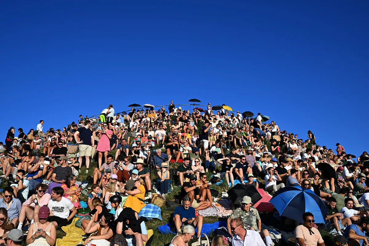 12 August 2026, Bavaria, Munich: People are watching a partial solar eclipse on Olympiaberg in Munich’s Olympiapark. According to the German Weather Service, when the partial solar eclipse is visible over Germany this evening, weather conditions will be ideal for viewing it almost everywhere at that time. Photo: Felix Hörhager/dpa (Photo by Felix Hörhager / dpa Picture-Alliance via AFP)