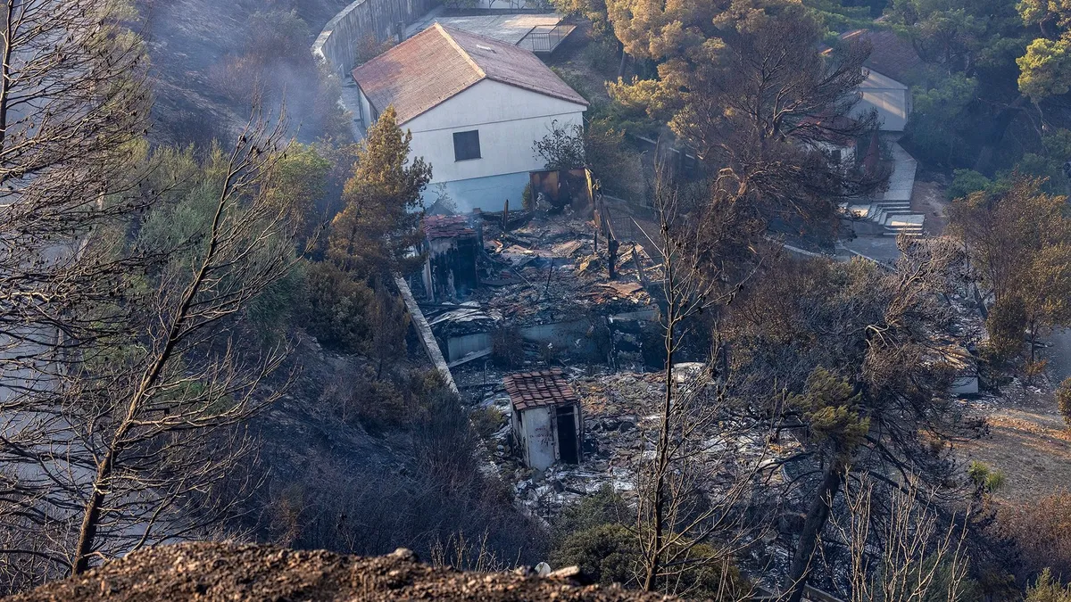 This photograph shows burnt houses after a wildfire near the town Omis, some 30 kilometres south of Split, on August 14, 2026. Croatian firefighters battled overnight with "one of the worst" wildfires in the country's history, authorities said on August 14, 2026, as flames engulfed homes and injured 19 people on the coast. Hundreds were forced to evacuate from villages near the town of Omis as the fire, which had begun in a settlement of Lokva Rogoznica, ripped through the surrounding hills. (Photo by MIROSLAV LELAS / AFP)