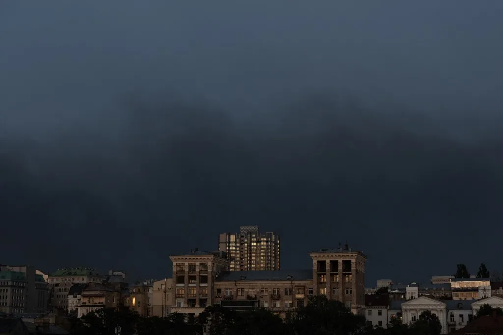 This photograph shows smoke rising over the buildings following a Russian air attack, in downtown Kyiv on August 20, 2026, amid the Russian invasion of Ukraine. (Photo by Roman PILIPEY / AFP)