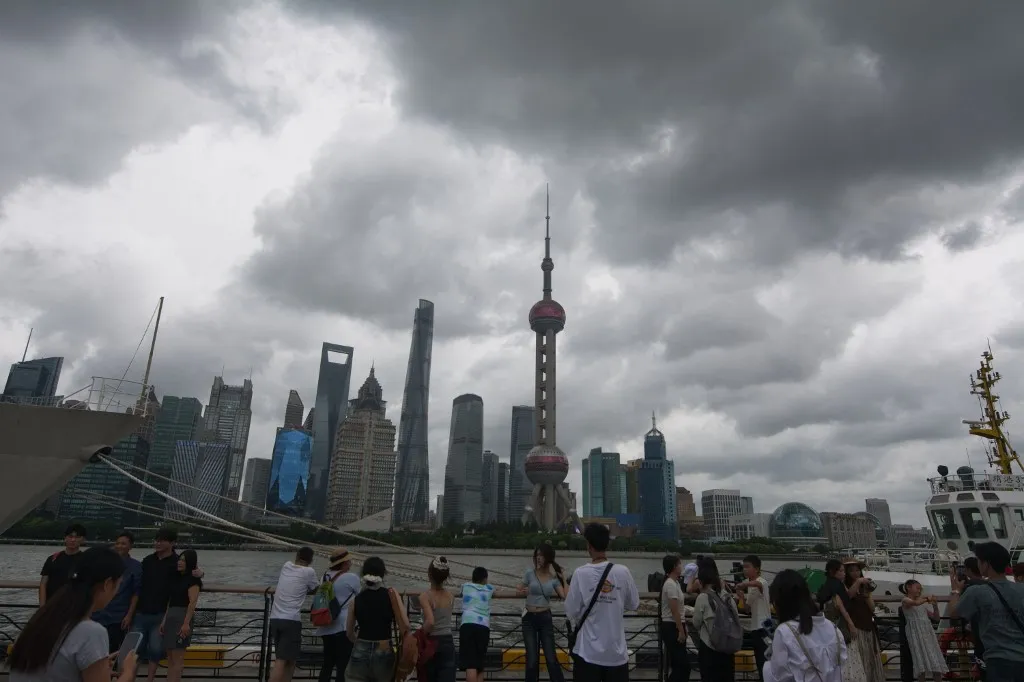 General view of tourists taking selfies at North Bund in Shanghai, China, as Typhoon Dolphin approaches the country. (Photo by Ying Tang/NurPhoto) (Photo by Ying Tang / NurPhoto via AFP)