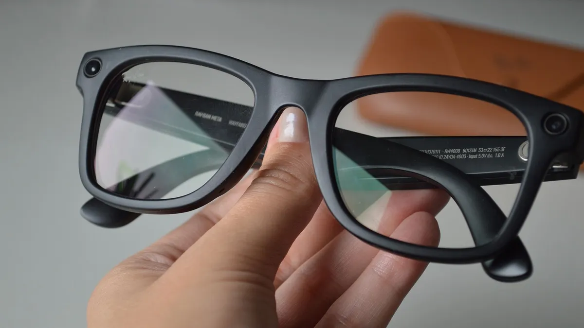 Warsaw, Poland - 12 October 2025: Hand holding modern Ray-Ban Meta smart glasses with integrated technology. Innovative wearable device combining classic eyewear design with AR, connectivity feature