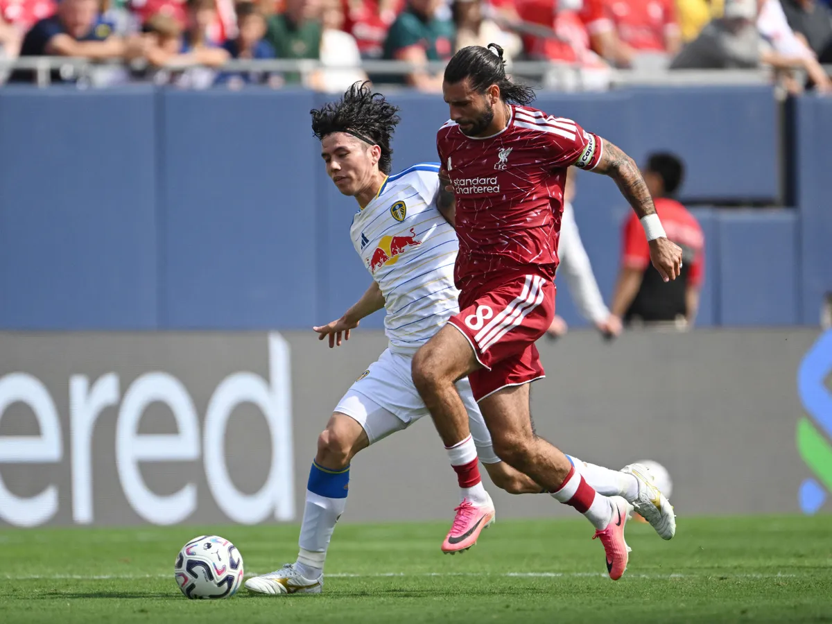 CHICAGO, ILLINOIS - AUGUST 02: Ao Tanaka #22 of Leeds United and Dominik Szoboszlai #8 of Liverpool FC battle for the ball during the first half at Soldier Field on August 02, 2026 in Chicago, Illinois. Daniel Bartel/Getty Images/AFP (Photo by Daniel Bartel / GETTY IMAGES NORTH AMERICA / Getty Images via AFP)