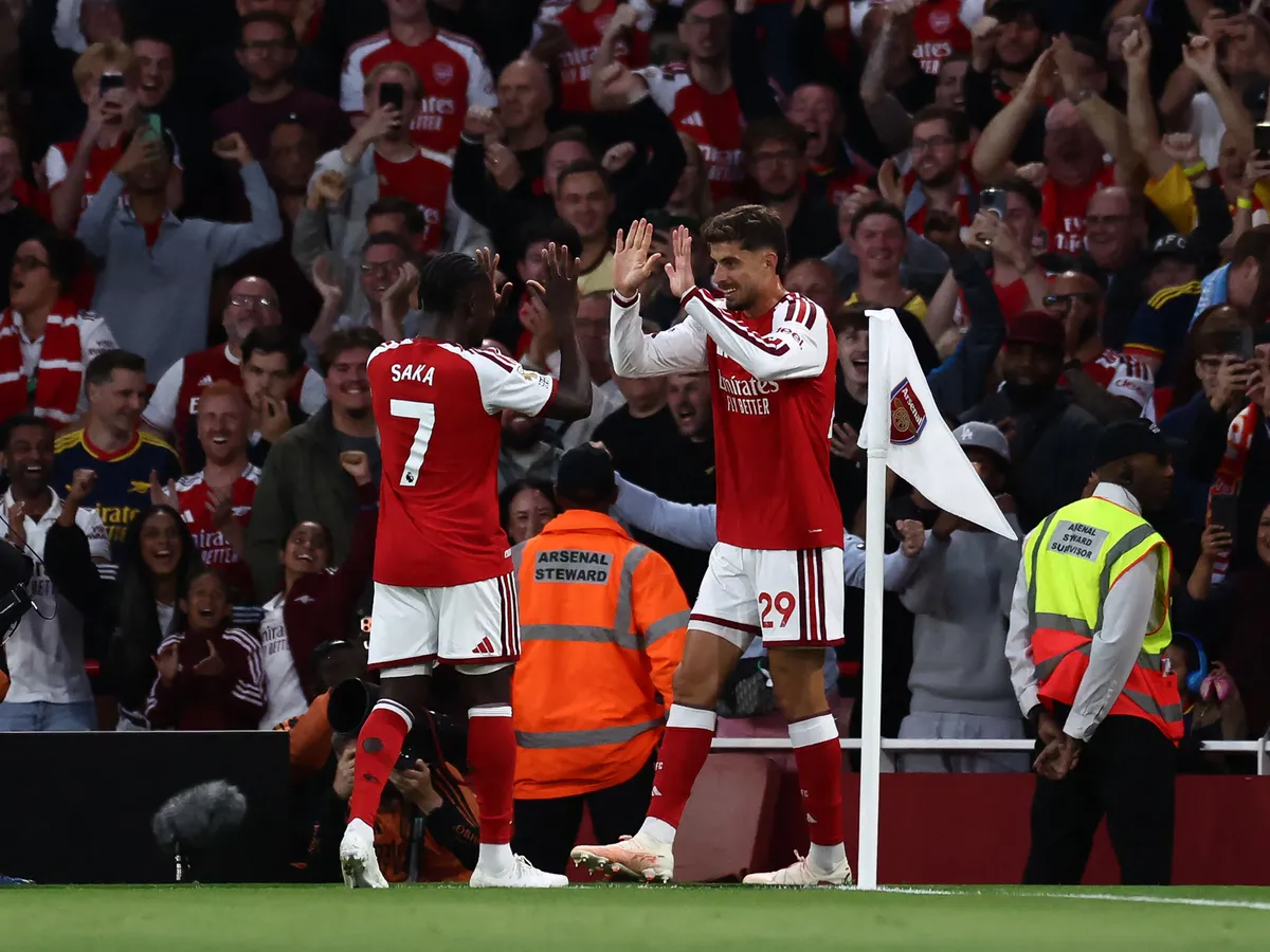 Arsenal's German midfielder #29 Kai Havertz celebrates scoring the team's first goal with Arsenal's English midfielder #07 Bukayo Saka during the English Premier League football match between Arsenal and Coventry City at the Emirates Stadium in London on August 21, 2026. (Photo by Henry NICHOLLS / AFP) / RESTRICTED TO EDITORIAL USE. No use with unauthorized audio, video, data, fixture lists, club/league logos or 'live' services. Online in-match use limited to 120 images. An additional 40 images may be used in extra time. No video emulation. Social media in-match use limited to 120 images. An additional 40 images may be used in extra time. No use in betting publications, games or single club/league/player publications. / 