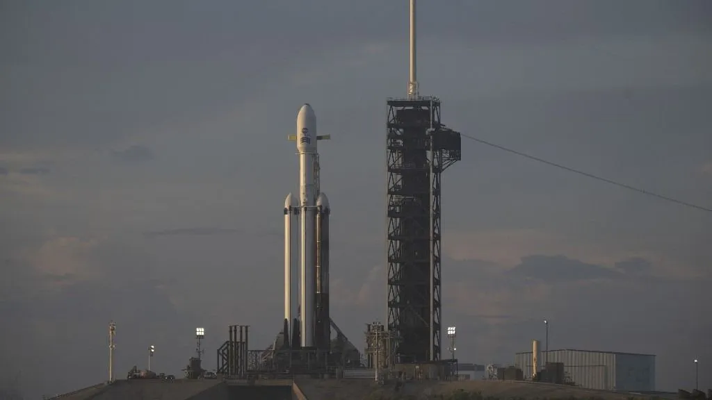 NASA CAPE CANAVERAL, FLORIDA - AUGUST 29: (EDITOR'S NOTE: This Handout image was provided by a third-party organization and may not adhere to Getty Images' editorial policy.) In this NASA handout, NASA's Nancy Grace Roman Space Telescope, encapsulated in a protective payload fairing atop a SpaceX Falcon Heavy rocket, is seen at sunrise on August 29, 2026, at Launch Complex 39A at NASA's Kennedy Space Center in Cape Canaveral, Florida. Roman will investigate dark energy and dark matter, conduct a statistical census of planetary systems, and enable a broad range of additional astrophysics research. Liftoff from NASA Kennedy is targeted for Aug. 30, 2026.   Joel Kowsky/NASA via Getty Images/AFP (Photo by NASA / GETTY IMAGES NORTH AMERICA / Getty Images via AFP)