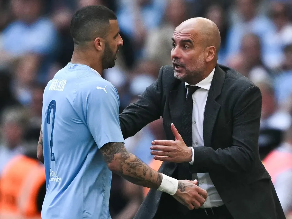 Manchester City's Spanish manager Pep Guardiola (R) speaks to Manchester City's English defender #02 Kyle Walker during the English FA Cup final football match between Manchester City and Manchester United at Wembley stadium, in London, on May 25, 2024. (Photo by Ben Stansall / AFP) / NOT FOR MARKETING OR ADVERTISING USE / RESTRICTED TO EDITORIAL USE