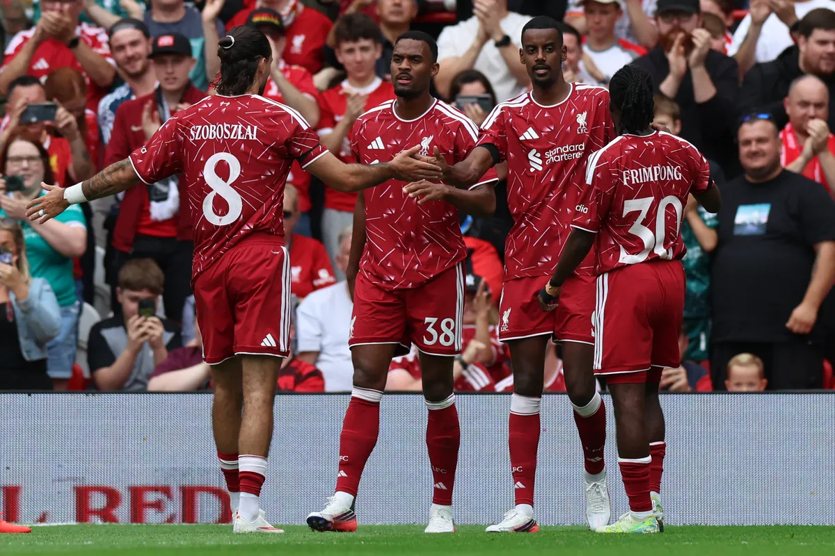 Liverpool's Swedish striker #09 Alexander Isak (2R) celebrates with teammates after scoring the opening goal during the pre-season friendly football match between Liverpool and Monaco at Anfield in Liverpool, north west England on August 9, 2026. (Photo by Darren Staples / AFP)