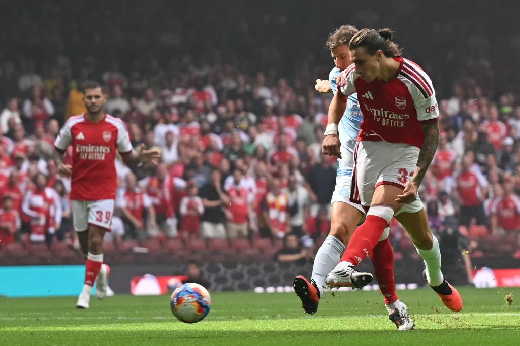 Arsenal's Italian defender #33 Riccardo Calafiori shoots to score the opening goal of the English FA Community Shield football match between Arsenal and Manchester City at The Principality Stadium, in Cardiff, south Wales on August 16, 2026. (Photo by Glyn KIRK / AFP)