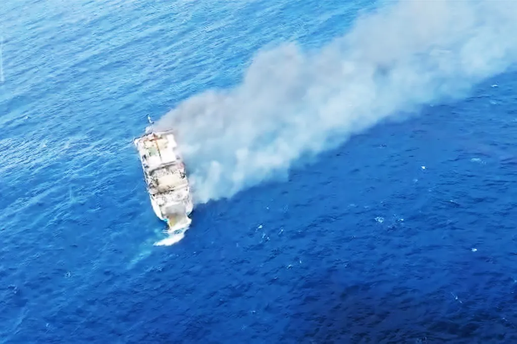 This screen grab picture from a handout video taken and released on August 12, 2026 by the Indonesian National Search and Rescue Agency (Basarnas) shows the Putri Yasmin ferry, which serves the Padangbai-Bali- to Lembar-West Nusa Tenggara route, on fire in the waters of Bali. (Photo by Handout (Green Road Waste Management ) / Indonesian National Search and Rescue Agency (BASARNAS) / AFP) / RESTRICTED TO EDITORIAL USE - MANDATORY CREDIT "AFP PHOTO / Indonesian National Search and Rescue Agency (BASARNAS)" - HANDOUT - NO MARKETING NO ADVERTISING CAMPAIGNS - DISTRIBUTED AS A SERVICE TO CLIENTS