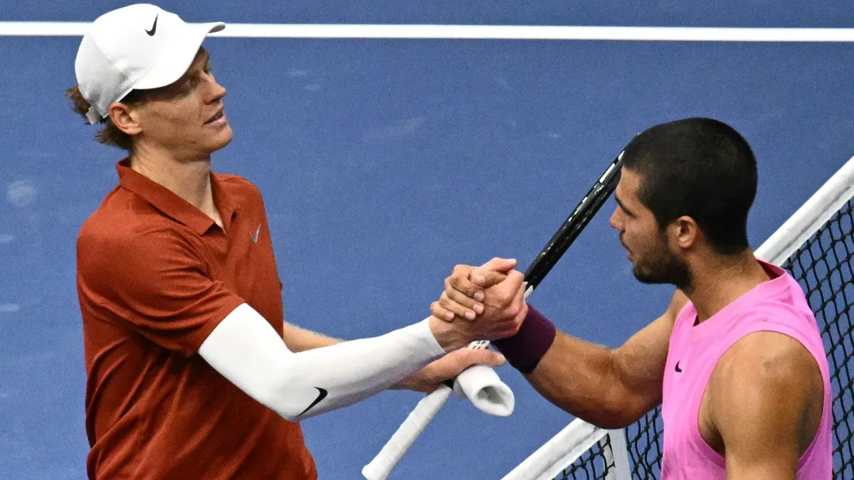 Italy's Jannik Sinner (L) and Spain's Carlos Alcaraz shake hands at the net after alcaraz won the men's singles final tennis match on day fifteen of the US Open tennis tournament at the USTA Billie Jean King National Tennis Center in New York City on September 7, 2025. (Photo by Mandel NGAN / AFP)