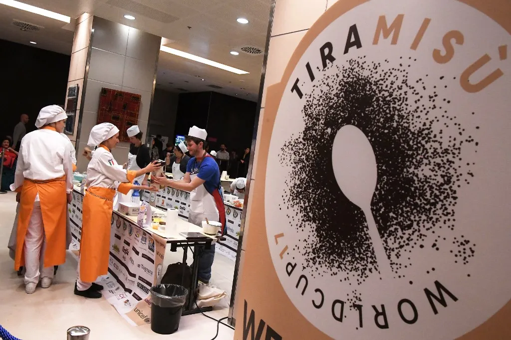 Competitors take part in the first Tiramisu World Cup competition on November 4, 2017 in Treviso. (Photo by MARCO BERTORELLO / AFP)