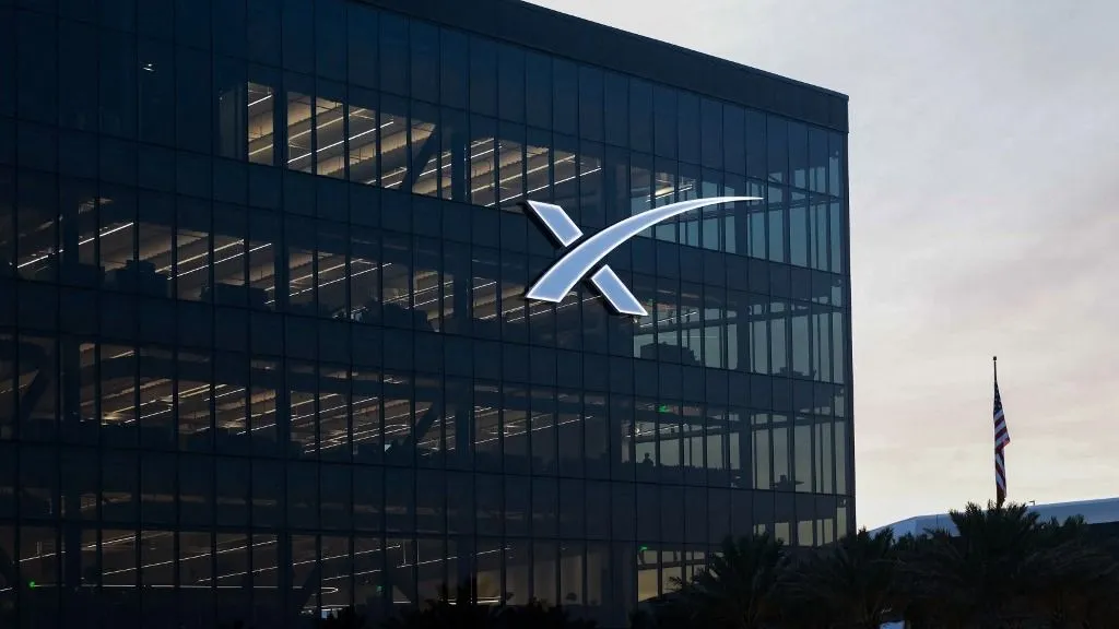 Elon Musk, SpaceX's logo is visible on a building at the company's South Texas facility in Cameron County, Texas, on July 22, 2026. (Photo by Reginald Mathalone/NurPhoto) (Photo by Reginald Mathalone / NurPhoto via AFP)